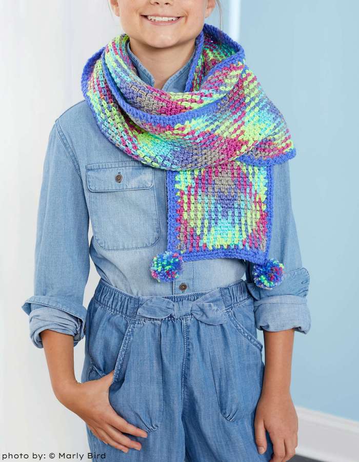 Girl in the Planned Pooling Pompom Scarf